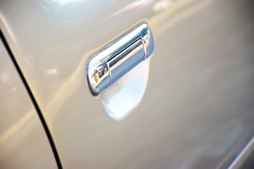 Silver handle for opening a parked brown car door