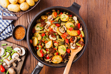 Fried pan vegetables, with mushrooms and dried tomatoes. Seasoned with a mix of herbs.