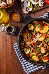 Fried pan vegetables, with mushrooms and dried tomatoes. Seasoned with a mix of herbs.