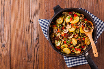 Fried pan vegetables, with mushrooms and dried tomatoes. Seasoned with a mix of herbs.