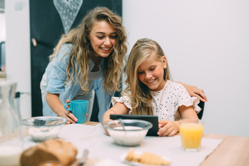 mother and daughter breakfast together at home