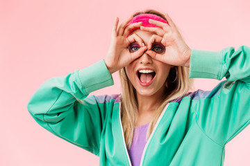 Image of delighted young woman showing ok gesture and smiling