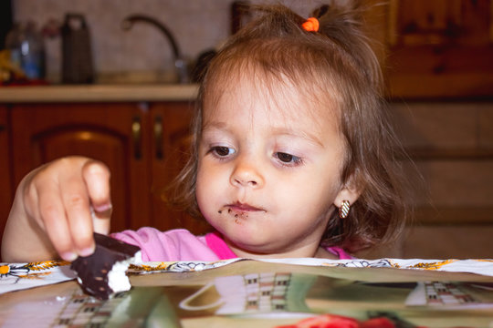 Little girl eating chocolate chip cookies. Kids concept and sweets