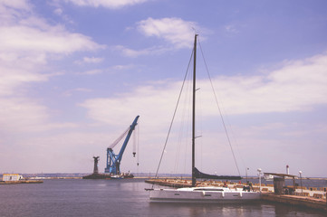Harbor with sailboats and yachts moored in the port.