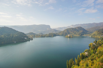 Fototapeta premium Travailing around Lake Bled In Slovenia an amazing lake full of impressive nature , crystal blue water with a beautiful island in the middle surrounded by those beautiful mountains and trees. 