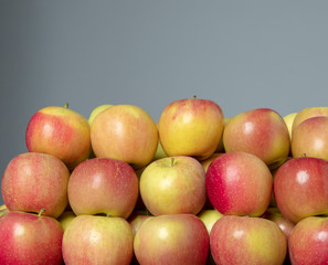 Full frame of red, green and yellow apples on the grey isolated background