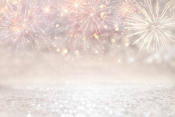 abstract gold and silver glitter background with fireworks. christmas eve, 4th of july holiday concept