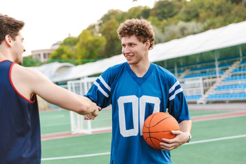 Fototapeta premium Two happy confident basketball players