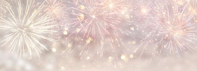 abstract gold and silver glitter background with fireworks. christmas eve, 4th of july holiday concept. banner