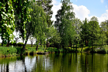Fototapeta na wymiar Landscape photo with the image of the lake, which reflects the trees.
