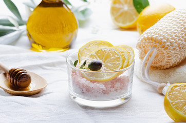 Ingredients for body scrub of pink salt with lemon and olive oil, eco bio friendly cosmetic for skin care.