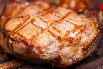 Pork steak on a wooden board