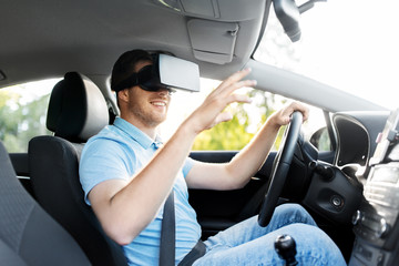virtual reality, technology and driving concept - smiling man or driver wearing vr glasses in car