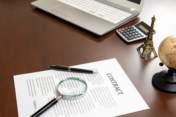 Contract documents and magnifiers on a businessman's desk