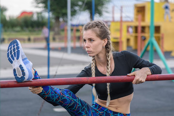 Fototapeta premium Girl stretches on the playground