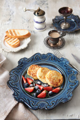 Cottage cheese fried tortillas in a ceramic blue plate. View from above. The concept of still life and wholesome food.
