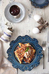 Viennese waffles on a blue ceramic plate with ice cream. View from above. Concept of still life and healthy breakfast.