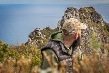 Man in camo on mountain ridge 