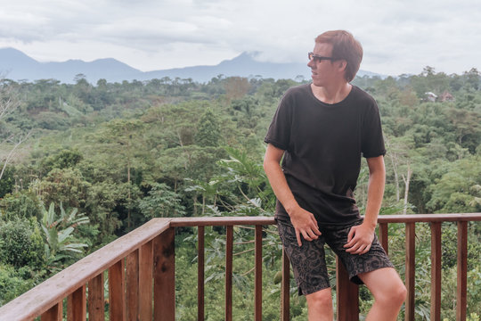 man stands on the balcony of the hotel