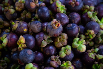 heap of mangosteen in market .