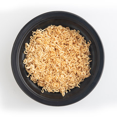 Instant noodles in a black Bowl. Isolated on white
