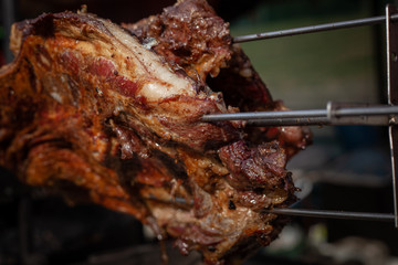 Marinated fried pork ribs cooked on a skewer over charcoal