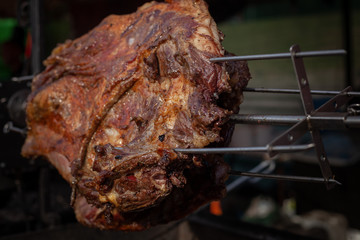 Marinated fried pork ribs cooked on a skewer over charcoal