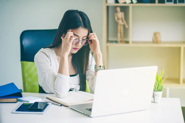 serious young woman sitting with laptop.Asian business woman