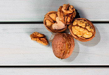 Cracked walnuts, nuts on shell on wooden table, top view image