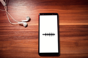 Smartphone with equalizer icon on screen