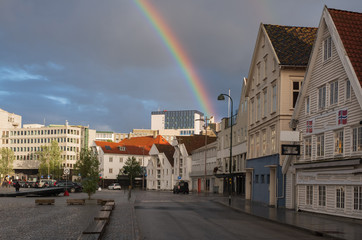 Stavanger, Norway - July 2019: The harbour in Stavanger city. This area is called Vagen. Evening with the rainbow