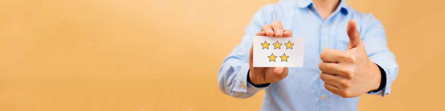Web banner of Businessman showing five yellow stars card and thumbs up in bright color background. Review, rating, ranking and evaluation concept