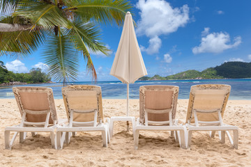 chairs and umbrella on the beach of Seychelles 