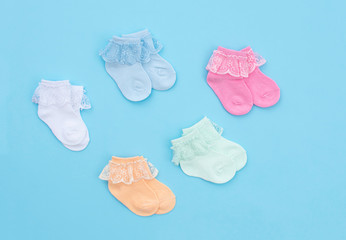 Baby socks on blue background.