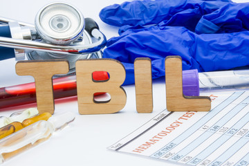 TBIL laboratory medical abbreviation of total bilirubin concept photo. On table is laboratory...
