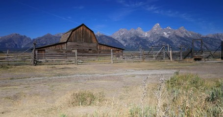 Mormon Row pioneer barn Grand Teton National Park. Pioneer settler homestead farms ranch. Historic building scenic landscape. 2.5 million visitors a year. Geography, geology, environment.