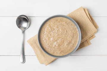 Mushroom cream soup on a wooden background