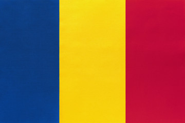 Romania national fabric flag, textile background. Symbol of international world european country.
