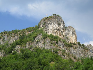 Fototapeta na wymiar Round rocky mountain top with a cross