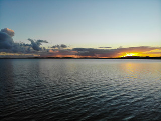 Sunset shot over the horizon with ripples (right)