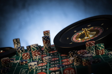 Roulette table in casino, with many games.  Golden and luxury light, casino interior