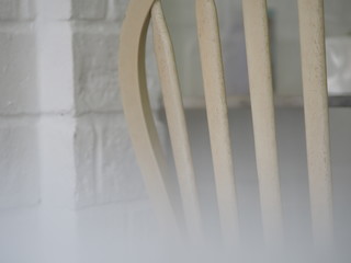 Selective focus closeup chair back made white grille wooden material background