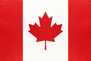Canada national fabric flag, textile background. Symbol of international world north America country.