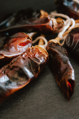 Hot chilli pepper on black background with rustic cloth, vintage tablecloth. Spicy traditional with copyspace.