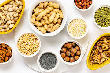 Various Nuts and Seeds on White Background in the Bowls - Image