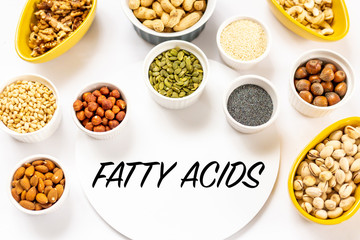 Top View of Variety of Nuts and Seeds on the White Background with Fatty Acids Text Copy