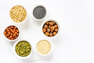 Top View of Variety of Nuts and Seeds on the White Background, Free Space for Text