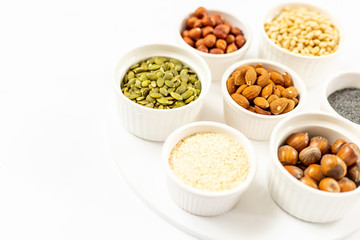 Top View of Variety of Nuts and Seeds on the White Background, Free Space for Text