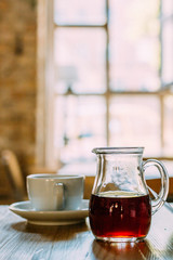 A Cup of Coffee on the Wooden Table in Modern Hipster Cosy Cafeteria