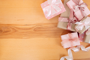 Set of beautiful gift boxes with pink bows on a wooden table. top view. flat lay